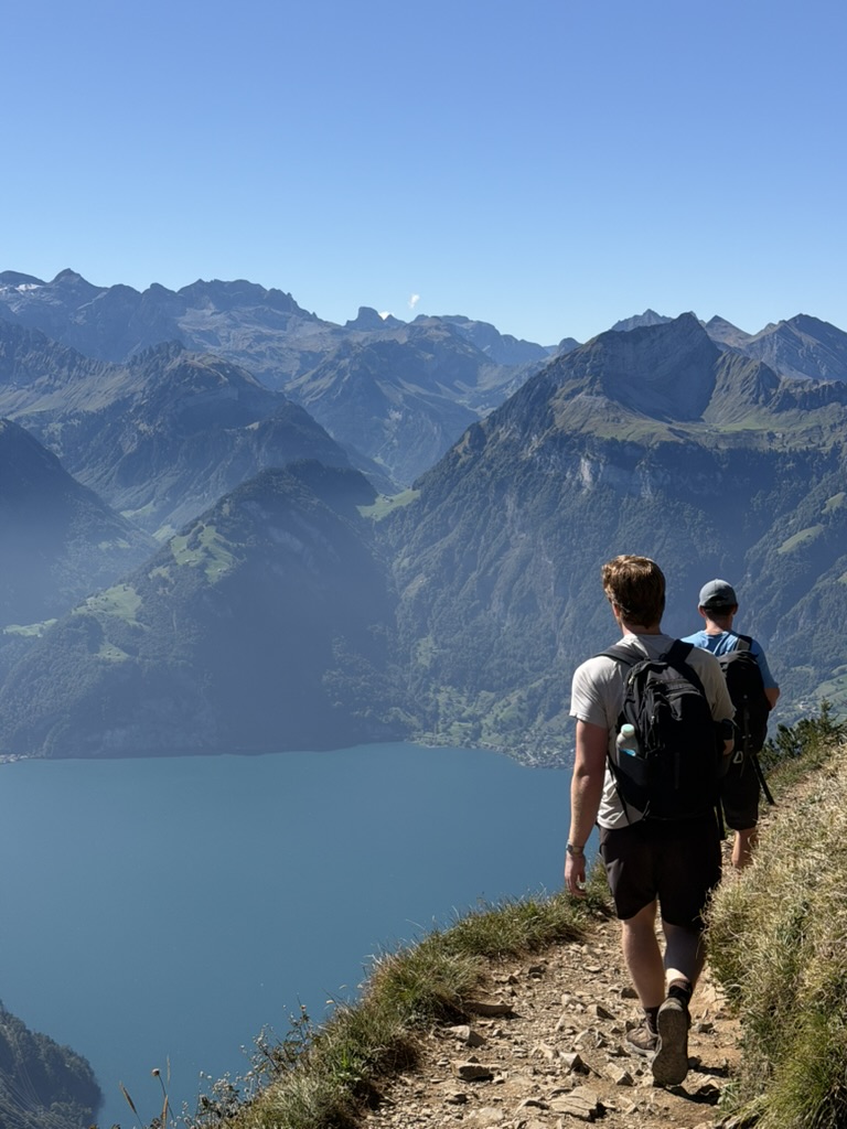 David West hiking above a lake in the Swiss Alps