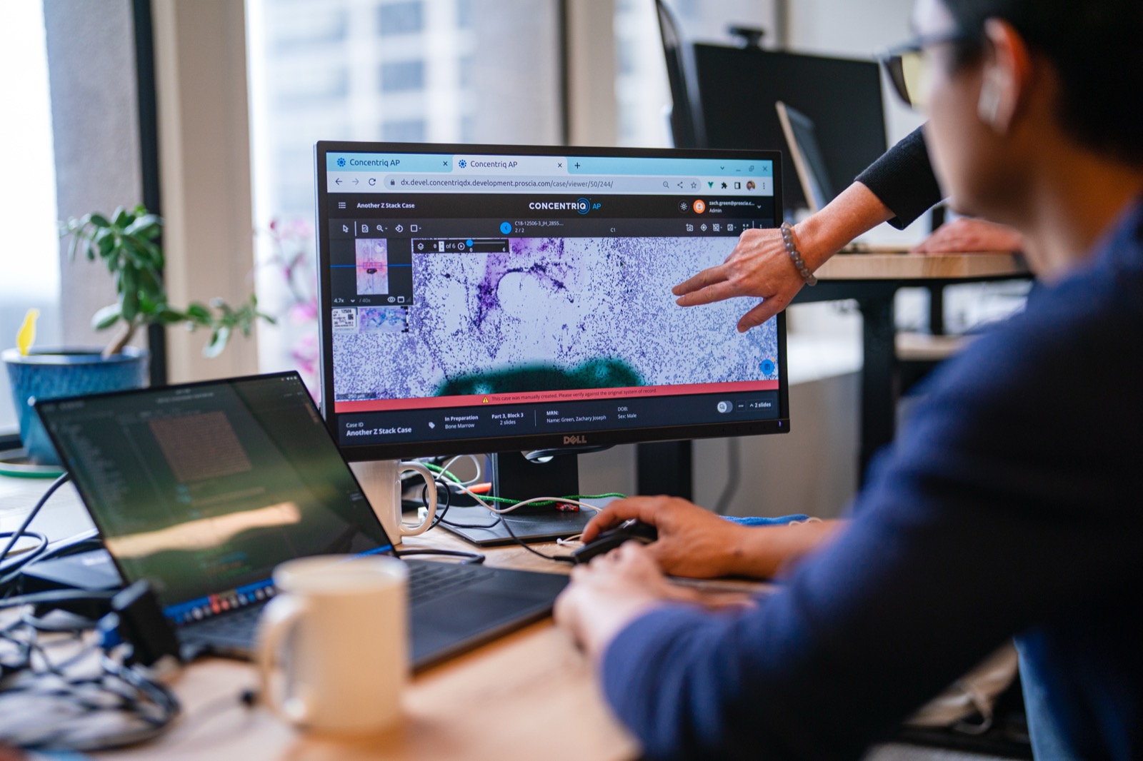 A Proscia colleague reviewing a case in the Concentriq AP digital pathology platform