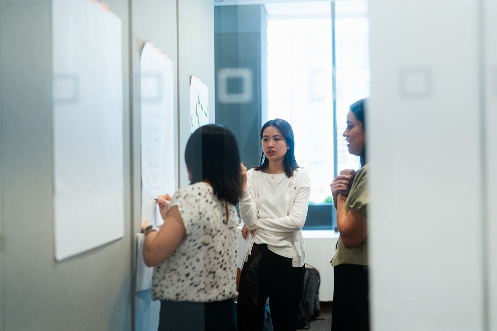 Colleagues at Proscia, the company David West founded, collaborating in the office